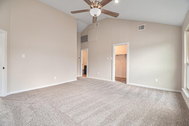 unfurnished bedroom featuring a spacious closet, ceiling fan, lofted ceiling, a closet, and carpet