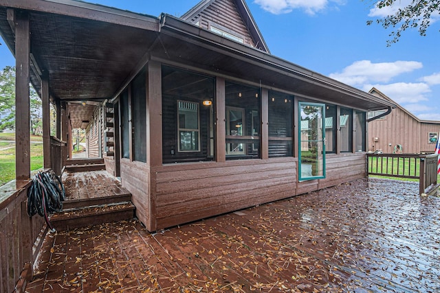 view of side of property featuring a sunroom