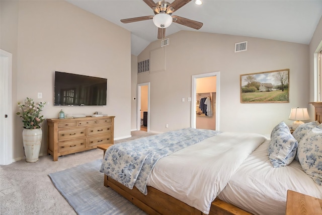 carpeted bedroom featuring ceiling fan, a closet, a spacious closet, and vaulted ceiling