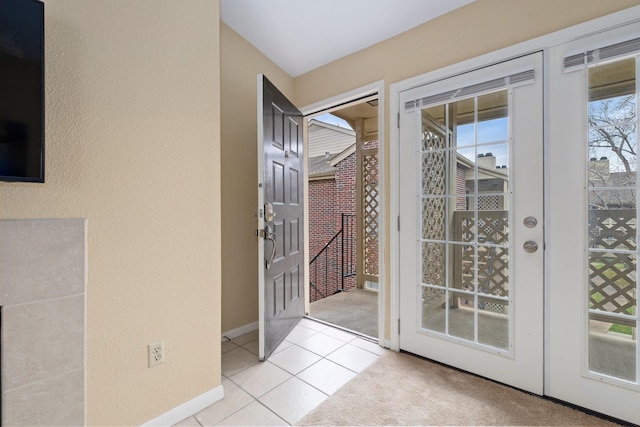 doorway to outside featuring french doors and light tile patterned floors