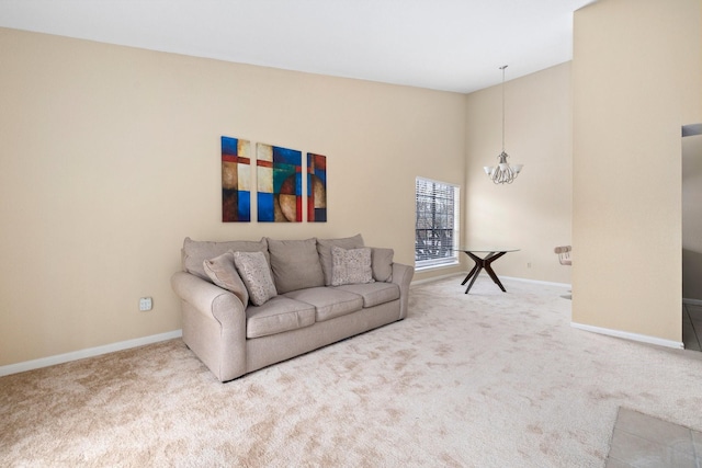 living room featuring carpet flooring and a notable chandelier