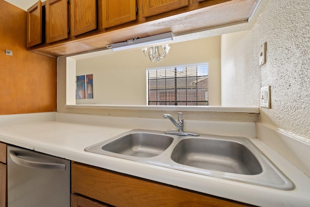 kitchen featuring dishwasher, a notable chandelier, and sink