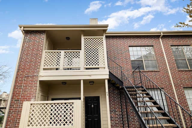 rear view of house featuring a balcony