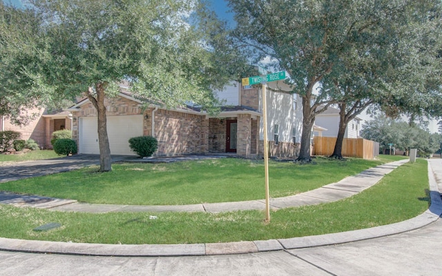 view of front of property with a garage and a front yard