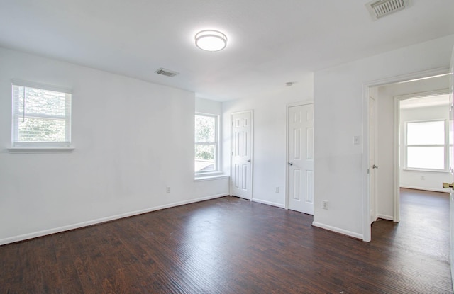 unfurnished room featuring dark wood-type flooring