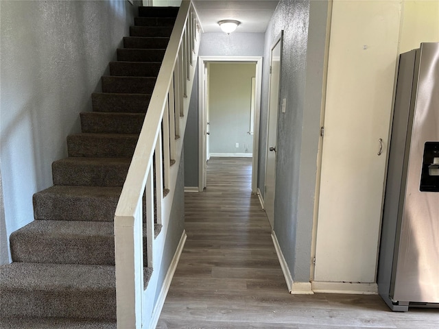 stairs with hardwood / wood-style flooring