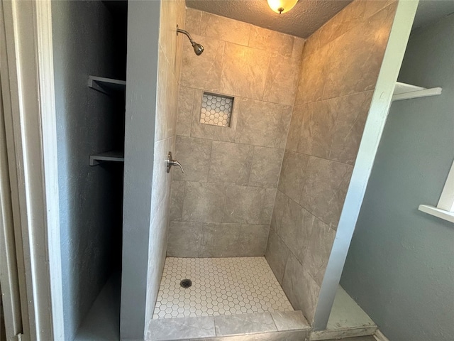 bathroom with tiled shower