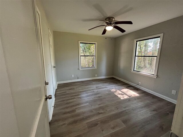 unfurnished bedroom featuring ceiling fan and dark wood-type flooring