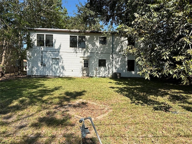 back of house with a lawn