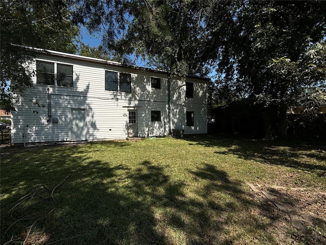 rear view of house with a yard