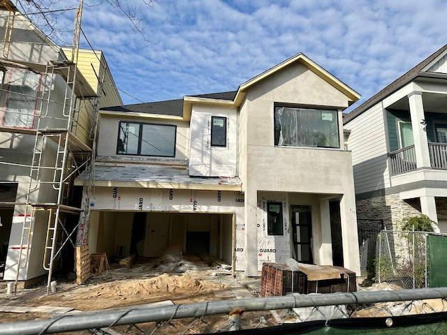 rear view of property featuring a garage