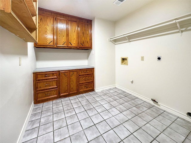 clothes washing area featuring cabinets, hookup for a washing machine, hookup for a gas dryer, and electric dryer hookup