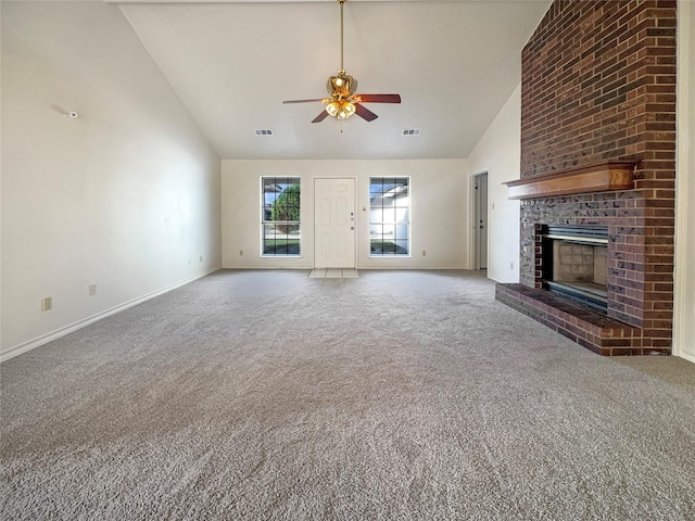 unfurnished living room with carpet, high vaulted ceiling, a brick fireplace, and ceiling fan