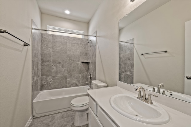 full bathroom featuring vanity, toilet, and tiled shower / bath