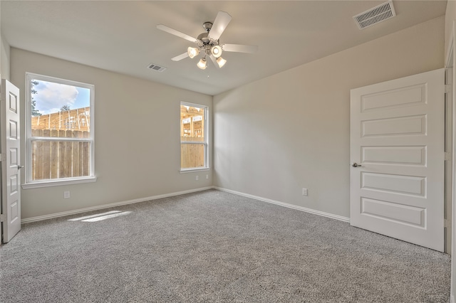 unfurnished room featuring ceiling fan and carpet