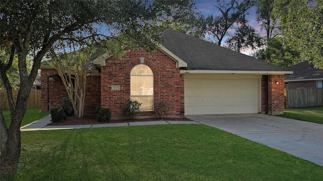 view of front facade featuring a lawn and a garage