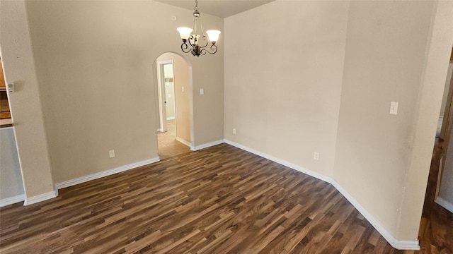 unfurnished dining area with dark hardwood / wood-style floors and an inviting chandelier