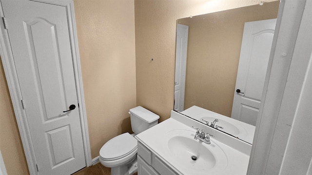 bathroom featuring tile patterned floors, vanity, and toilet