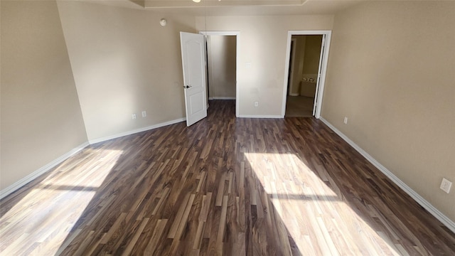 empty room with dark wood-type flooring