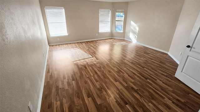 spare room featuring dark hardwood / wood-style floors