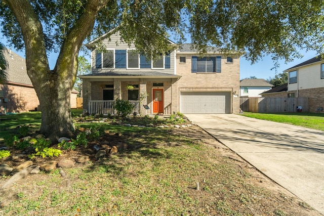 view of front of property with a front yard, a porch, and a garage