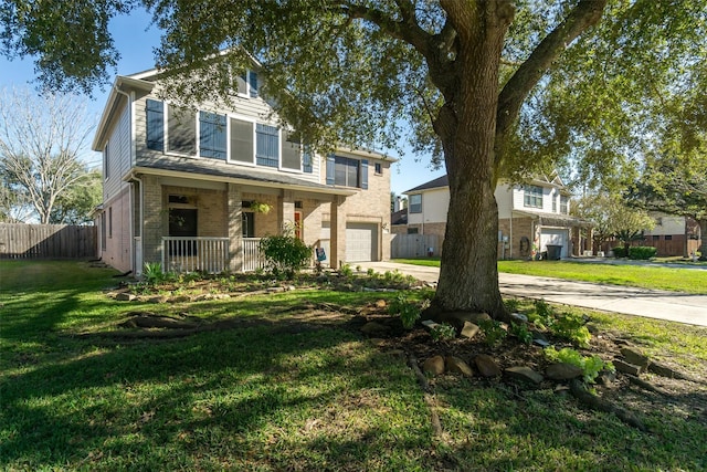 view of front of house featuring a porch, a garage, and a front lawn