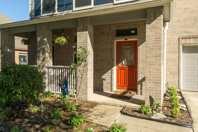 entrance to property featuring a porch and a garage