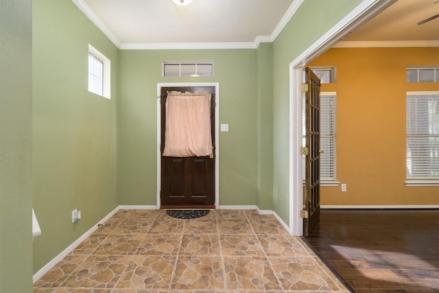 entrance foyer with ceiling fan and crown molding