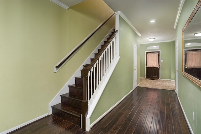 stairway with crown molding and hardwood / wood-style flooring