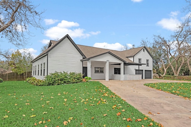 view of front of home featuring a garage and a front lawn