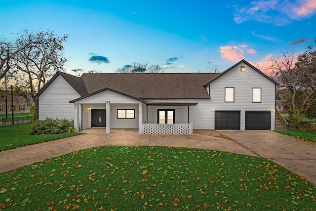 view of front facade featuring a lawn and a garage