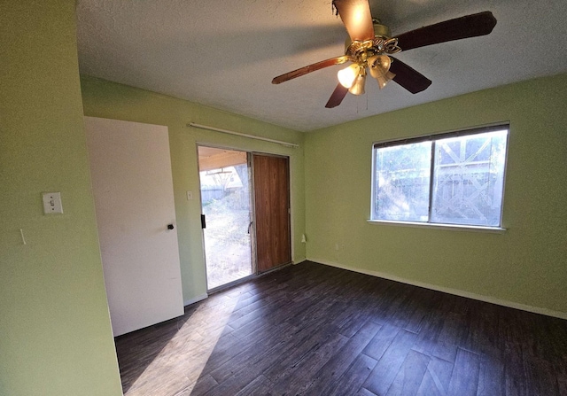 unfurnished room featuring dark hardwood / wood-style flooring and ceiling fan