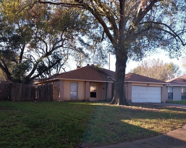 single story home featuring a front yard and a garage