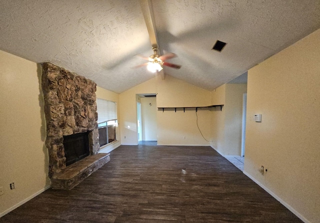 unfurnished living room featuring lofted ceiling, ceiling fan, dark hardwood / wood-style floors, and a textured ceiling