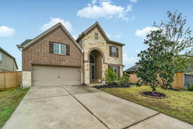 view of front of property featuring a front yard and a garage