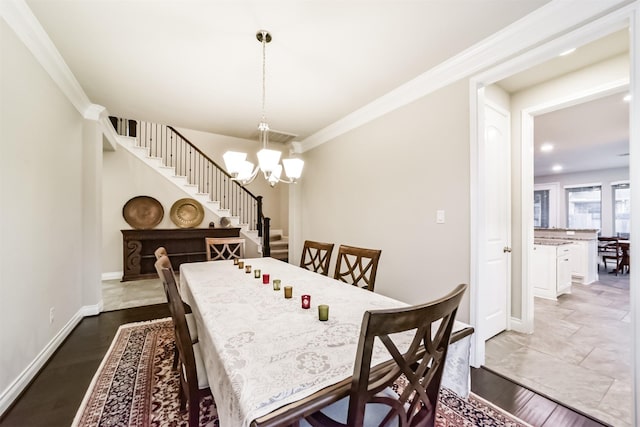 dining room featuring hardwood / wood-style floors, a notable chandelier, and crown molding