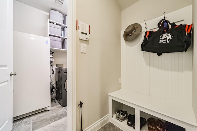 mudroom with independent washer and dryer