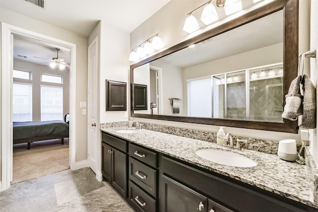 bathroom featuring ceiling fan, a shower with door, and vanity