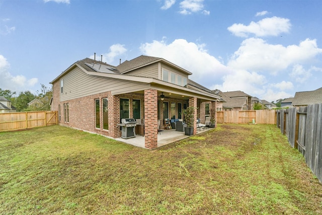 back of house with outdoor lounge area, a yard, and a patio