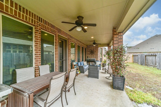 view of patio with an outdoor living space, area for grilling, and ceiling fan