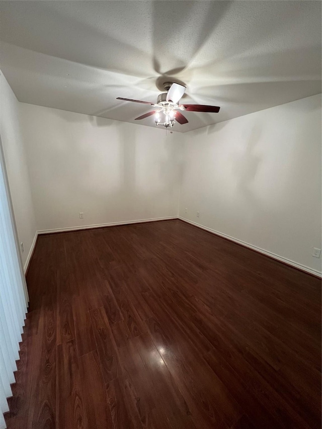 unfurnished room featuring ceiling fan and dark hardwood / wood-style flooring