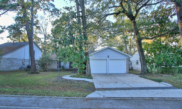 view of front of property with a front yard and a garage