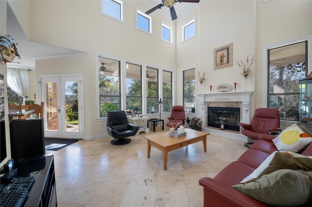 living room with ceiling fan, french doors, and a towering ceiling