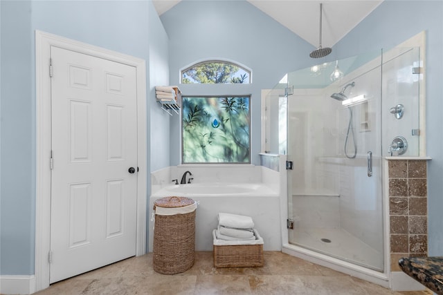 bathroom featuring shower with separate bathtub and lofted ceiling