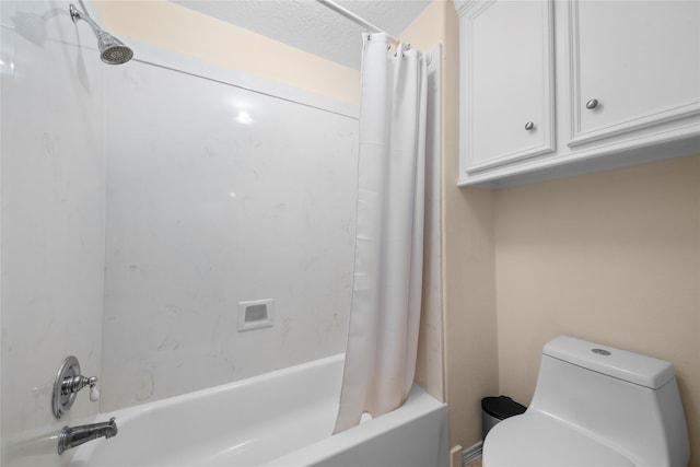 bathroom featuring a textured ceiling, toilet, and shower / bath combo with shower curtain