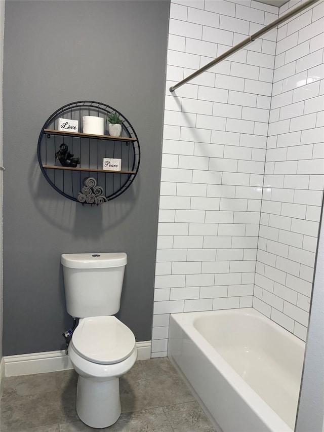 bathroom featuring tiled shower / bath and toilet