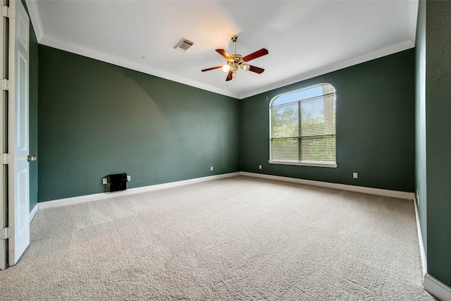 empty room with carpet, ceiling fan, and crown molding