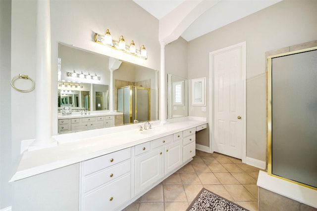 bathroom featuring tile patterned floors, vanity, walk in shower, and decorative columns