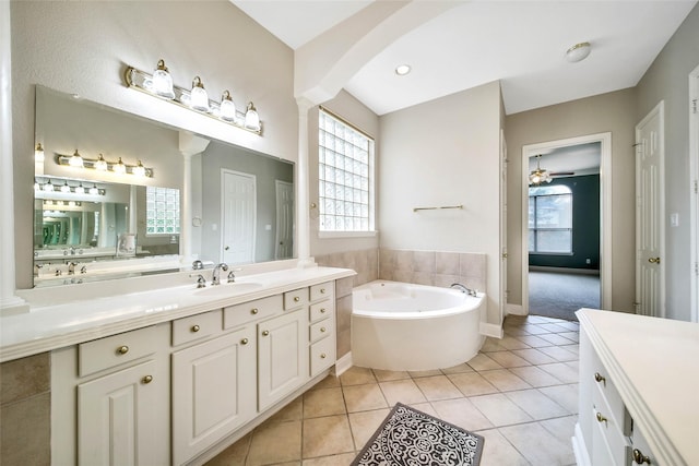 bathroom featuring tile patterned floors, a bathtub, ceiling fan, and vanity