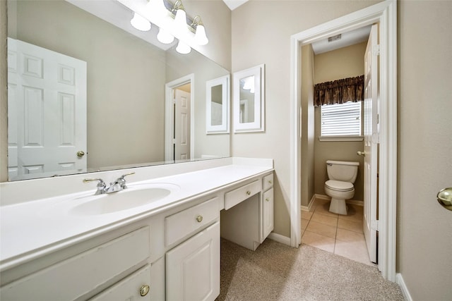 bathroom featuring tile patterned flooring, vanity, and toilet